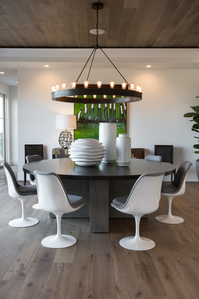 Medium sized modern kitchen/dining room in Orange County with white walls and medium hardwood flooring.