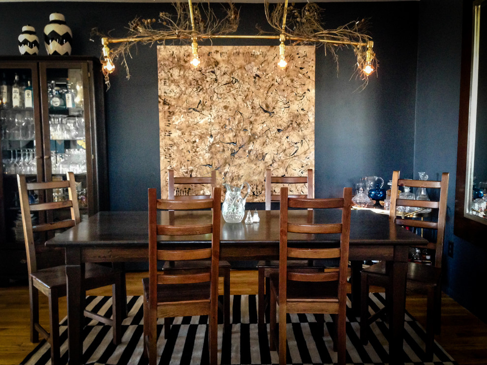 Idée de décoration pour une salle à manger ouverte sur la cuisine bohème de taille moyenne avec un mur bleu et parquet clair.