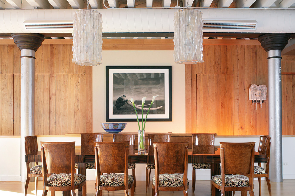 This is an example of a contemporary enclosed dining room in New York with medium hardwood flooring and no fireplace.