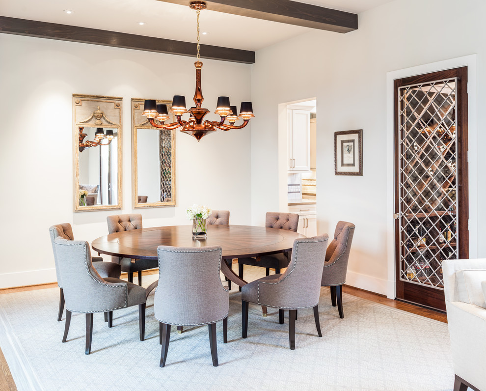 Photo of a classic dining room in Houston with white walls and medium hardwood flooring.
