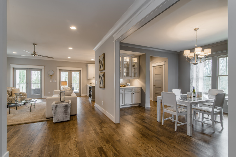 Inspiration for a mid-sized transitional medium tone wood floor enclosed dining room remodel in Nashville with gray walls