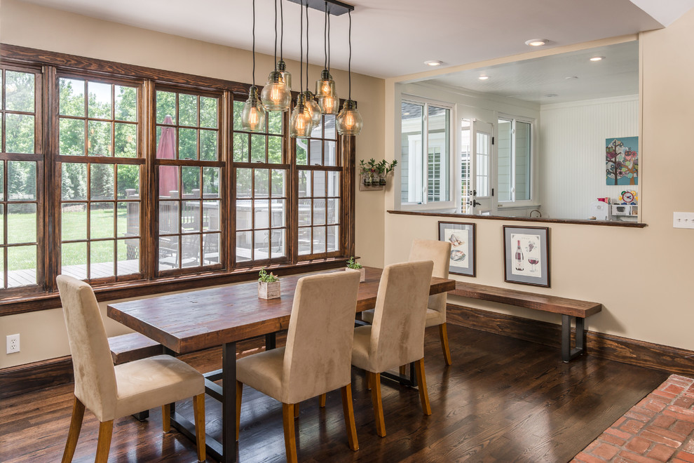 Classic kitchen/dining room in Nashville with beige walls, dark hardwood flooring and brown floors.