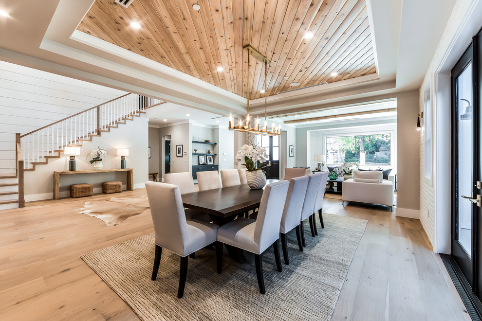 Inspiration for a transitional medium tone wood floor and brown floor dining room remodel in Los Angeles with gray walls
