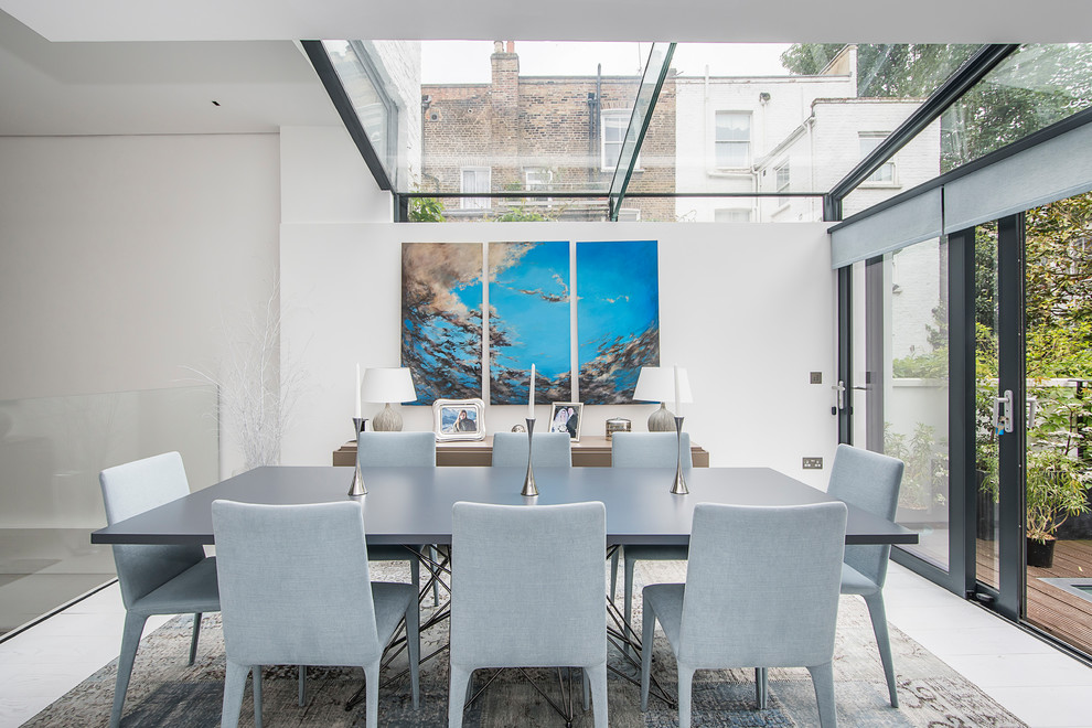 Photo of a contemporary dining room in London with feature lighting.