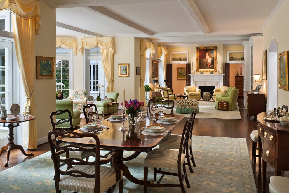 Источник вдохновения для домашнего уюта: большая гостиная-столовая в классическом стиле с желтыми стенами, паркетным полом среднего тона, стандартным камином, фасадом камина из дерева и коричневым полом