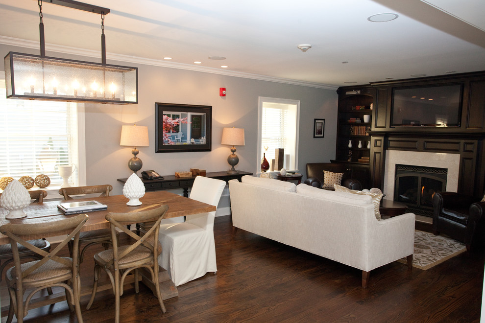 Example of a mid-sized trendy dark wood floor great room design in Chicago with gray walls and no fireplace