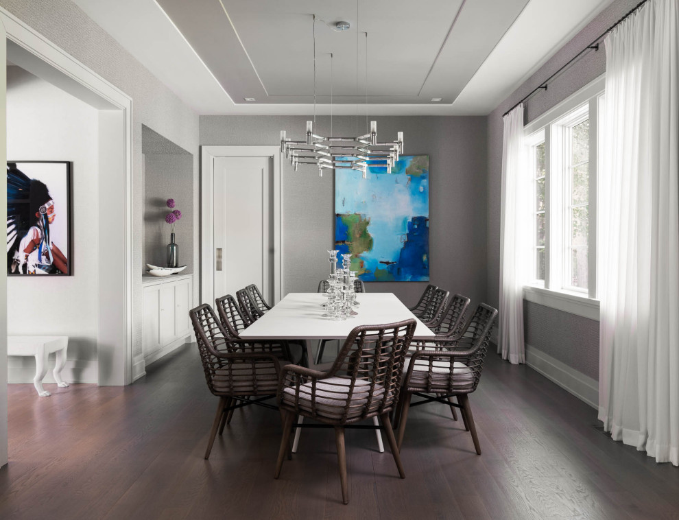 Cette photo montre une salle à manger bord de mer avec un mur gris, parquet foncé et un sol marron.