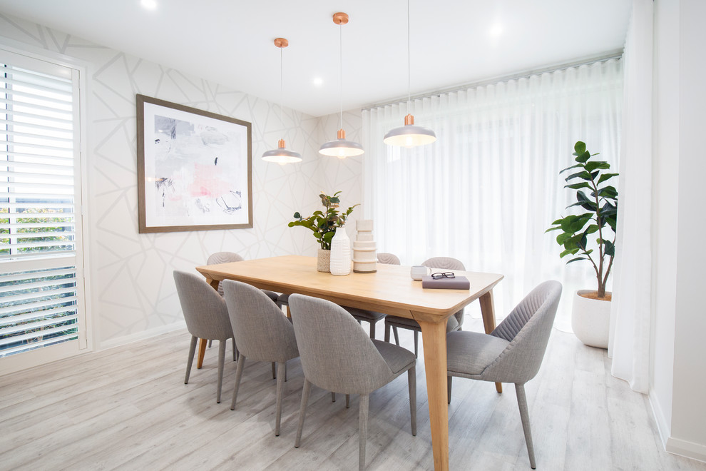 Contemporary dining room in Sydney with white walls, light hardwood flooring, no fireplace and grey floors.