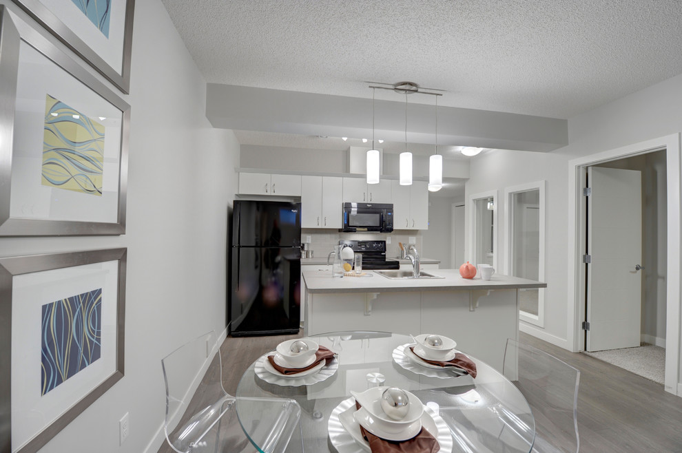 Photo of a small classic kitchen/dining room in Edmonton with grey walls and laminate floors.
