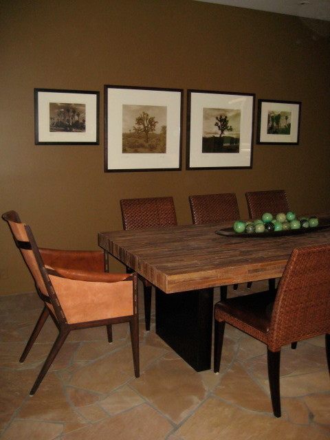 Immagine di una sala da pranzo aperta verso la cucina stile americano di medie dimensioni con pareti marroni, pavimento in pietra calcarea e nessun camino