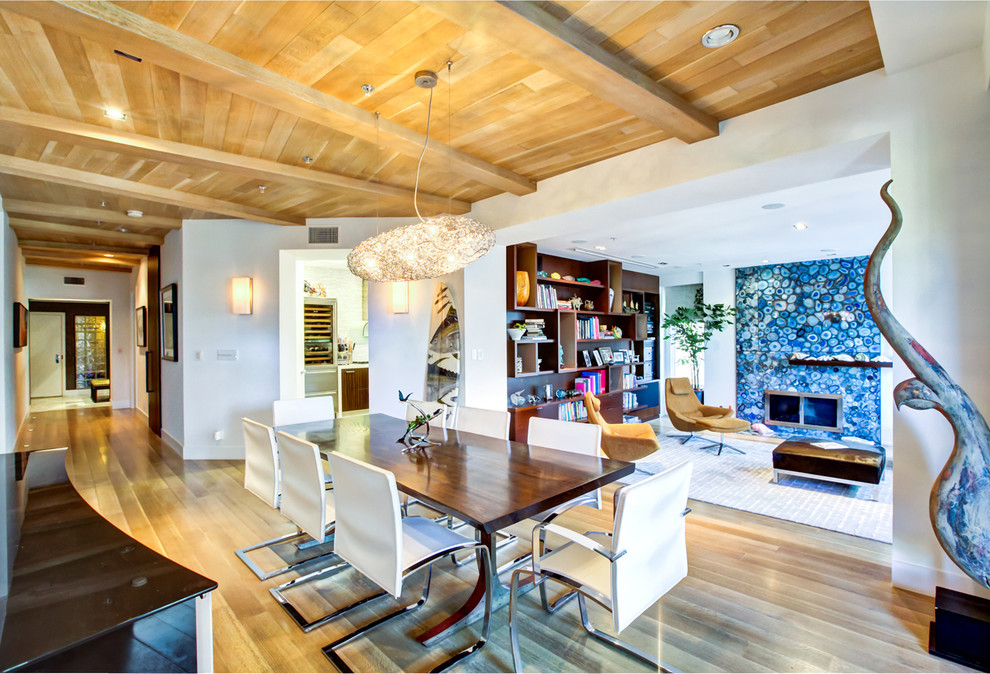 Inspiration for a contemporary dining room in Los Angeles with white walls and medium hardwood flooring.