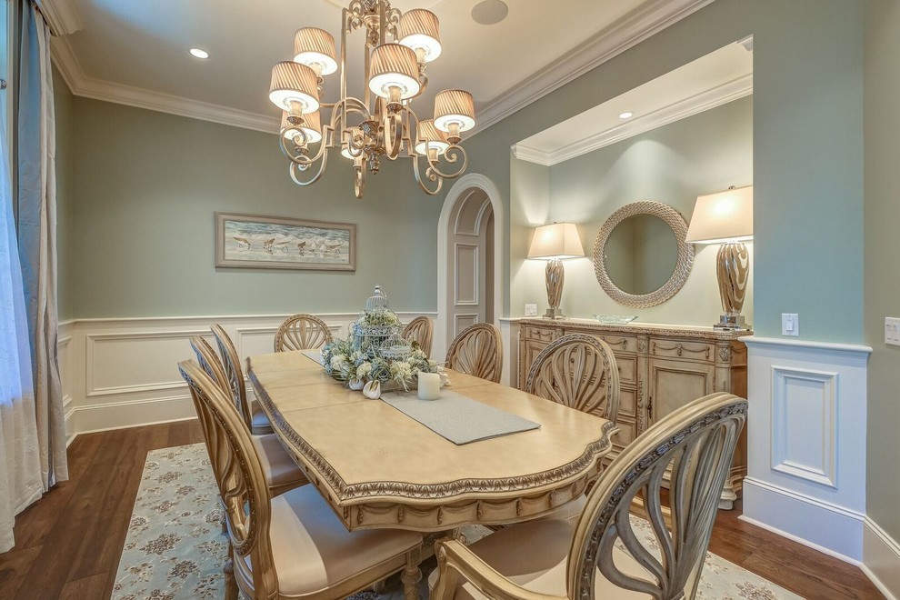 This is an example of a large classic enclosed dining room in Atlanta with green walls, medium hardwood flooring and no fireplace.
