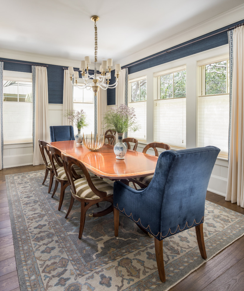 Traditional dining room in Charleston with blue walls and dark hardwood flooring.