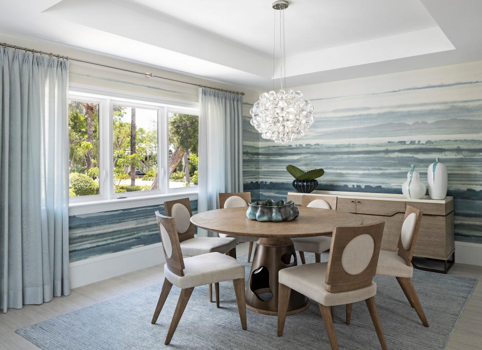 Example of a beach style gray floor dining room design in Detroit with blue walls
