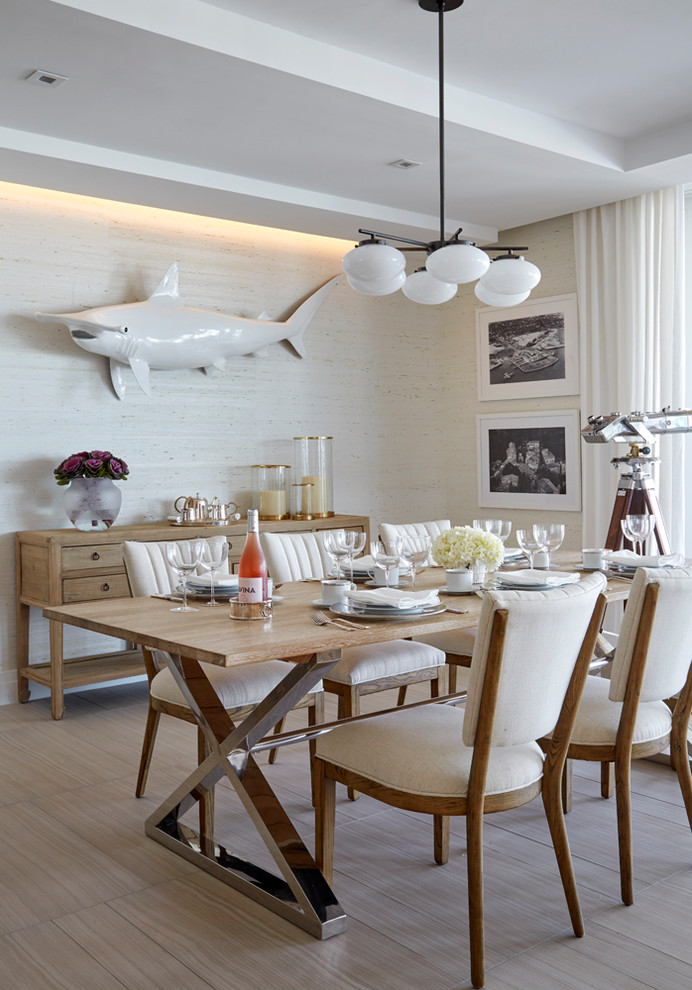 Inspiration for a nautical dining room in Miami with white walls and beige floors.