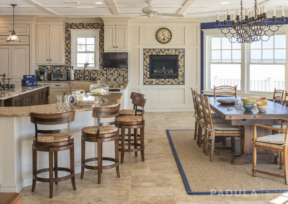 Cette image montre une salle à manger ouverte sur le salon rustique avec un mur bleu, un sol en carrelage de céramique, une cheminée standard et un manteau de cheminée en carrelage.