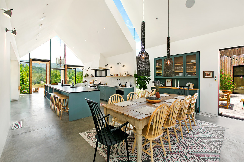 Foto de comedor de estilo de casa de campo abierto con paredes blancas, suelo de cemento y suelo gris
