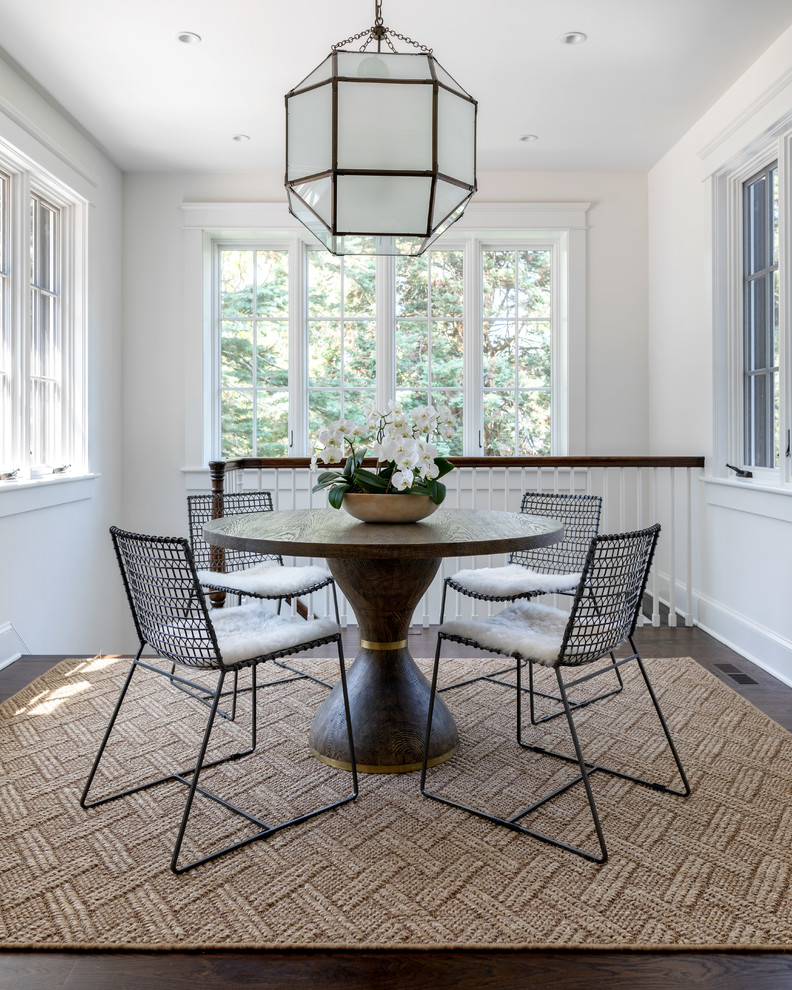 Classic dining room in New York with white walls, dark hardwood flooring and brown floors.