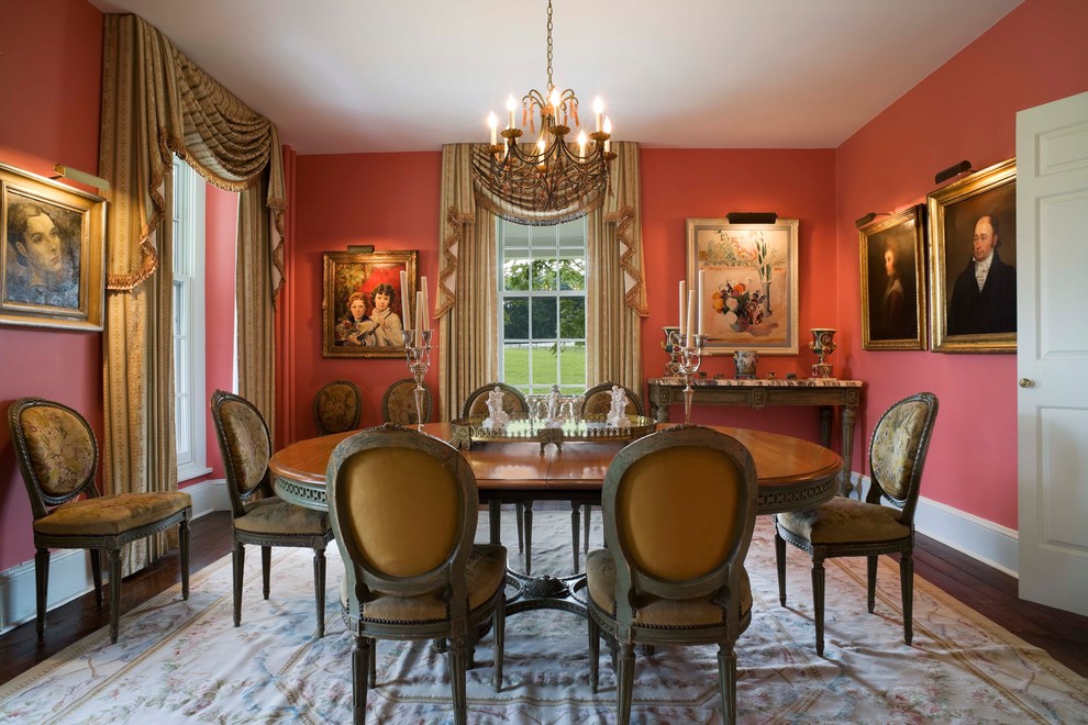 This is an example of a classic enclosed dining room in Philadelphia with dark hardwood flooring and pink walls.