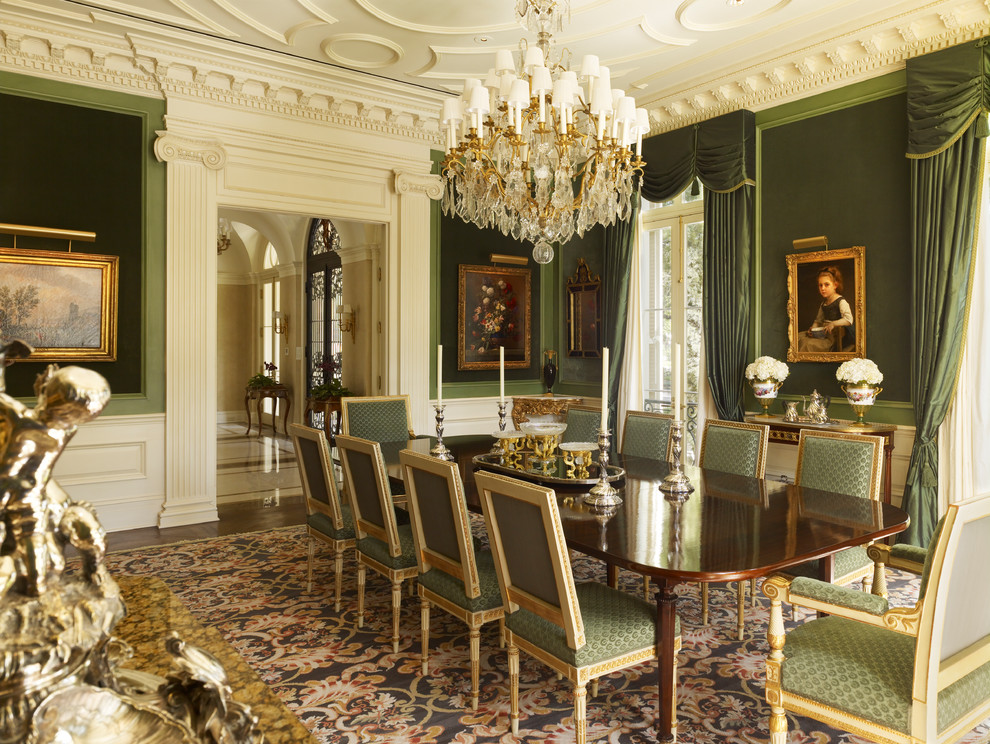 This is an example of a traditional enclosed dining room in New Orleans with green walls and dark hardwood flooring.