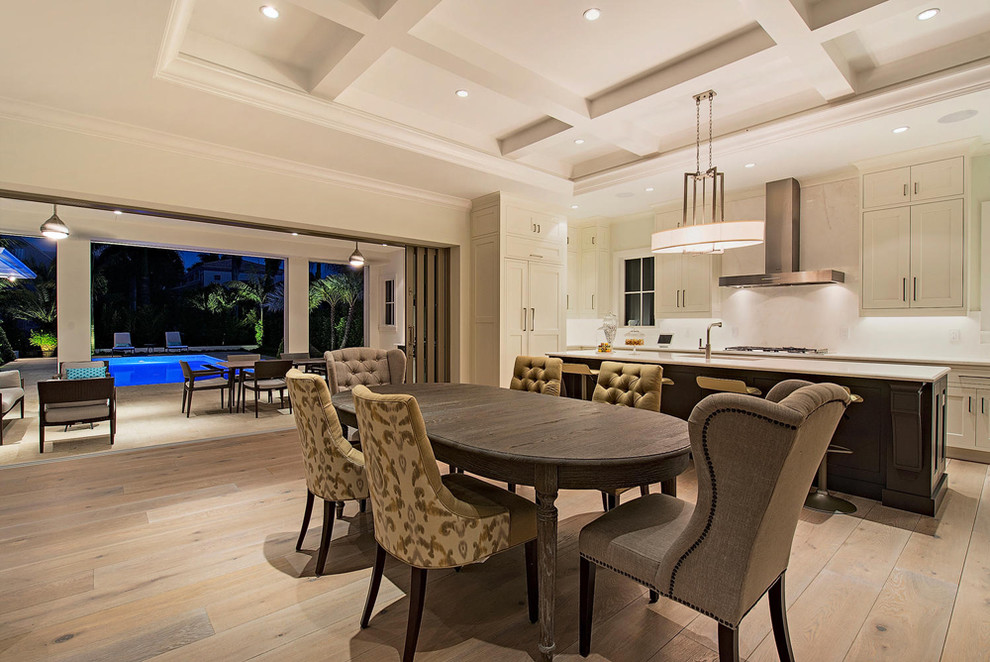 Trendy medium tone wood floor kitchen/dining room combo photo in Miami with beige walls