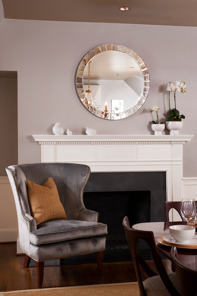 Example of a large classic dark wood floor dining room design in DC Metro with gray walls, a standard fireplace and a wood fireplace surround