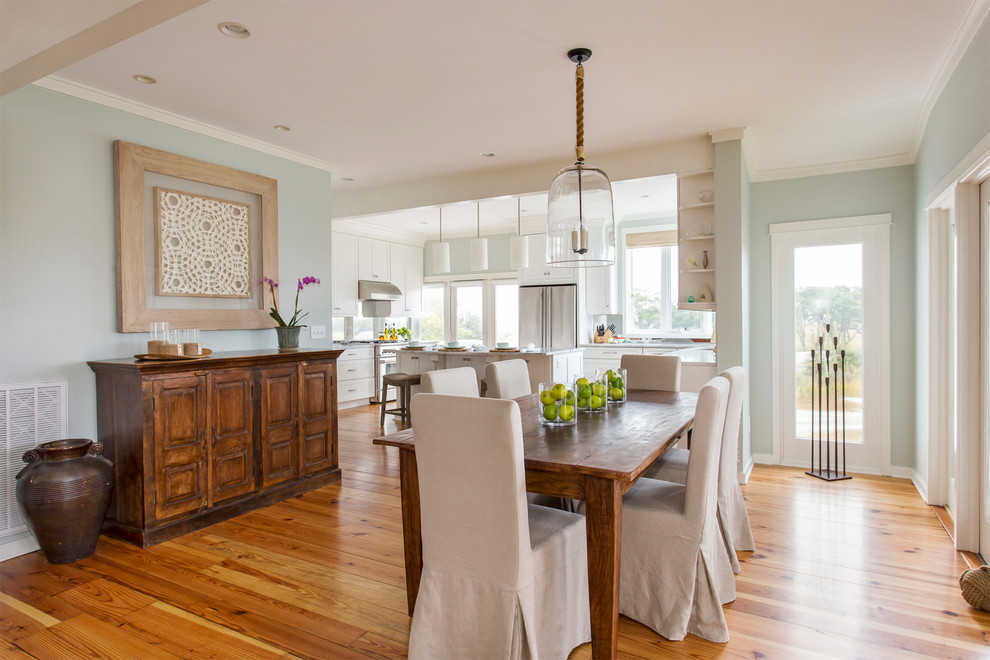 Example of a beach style medium tone wood floor dining room design in San Francisco with gray walls
