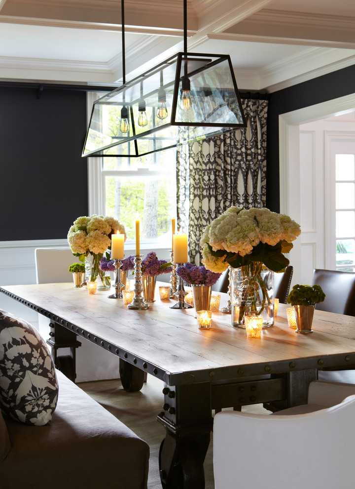 Example of a huge classic medium tone wood floor enclosed dining room design in New York with black walls and no fireplace