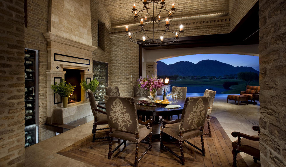 Tuscan dark wood floor dining room photo in San Diego with a standard fireplace