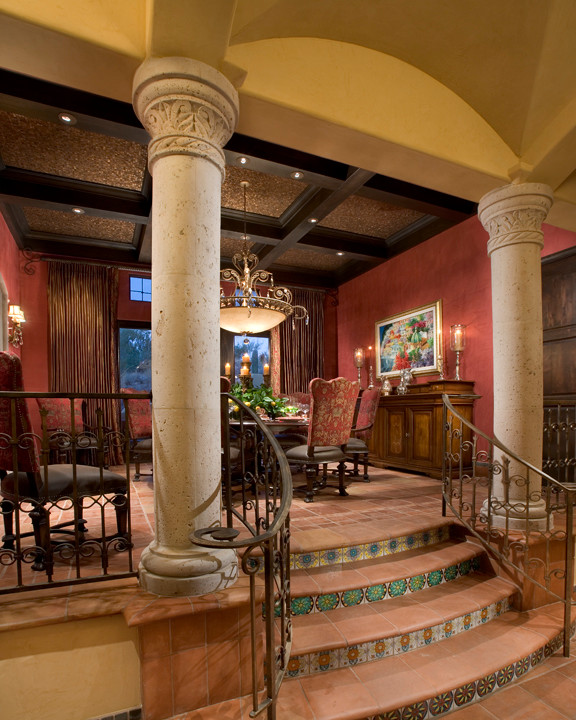 Inspiration for a large mediterranean brick floor and red floor enclosed dining room remodel in Phoenix with red walls
