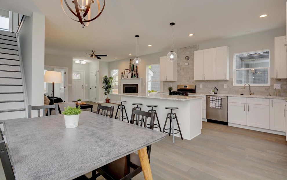 Example of a mid-sized transitional light wood floor and beige floor kitchen/dining room combo design in Columbus with gray walls and no fireplace