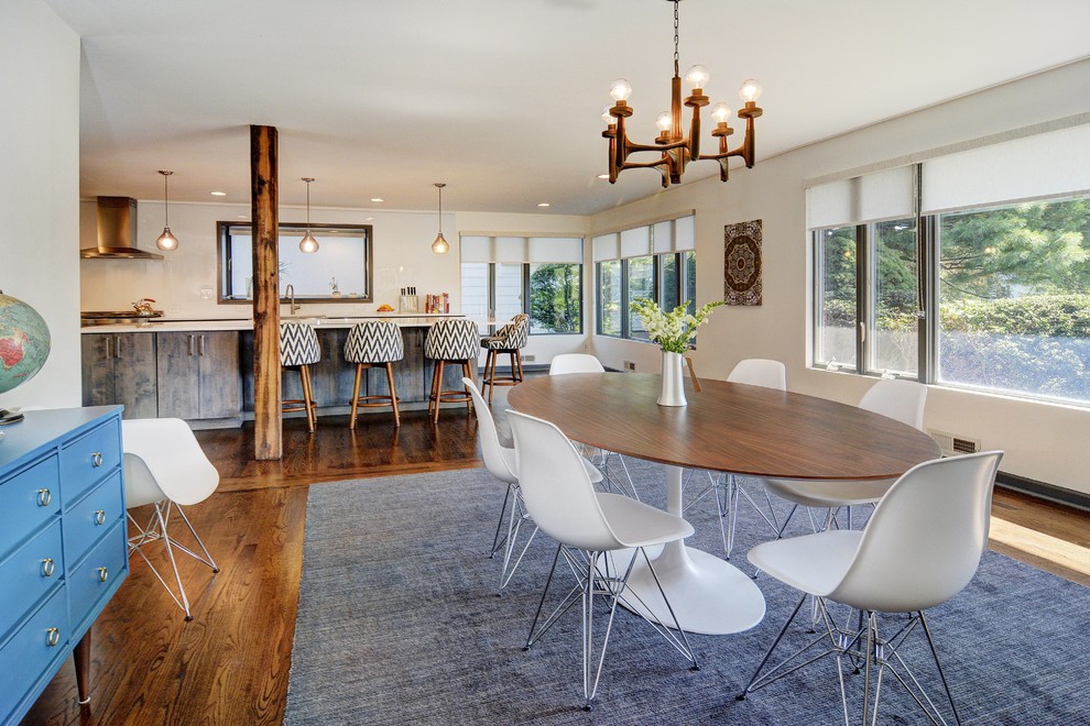 Photo of a contemporary dining room in San Francisco with white walls and medium hardwood flooring.