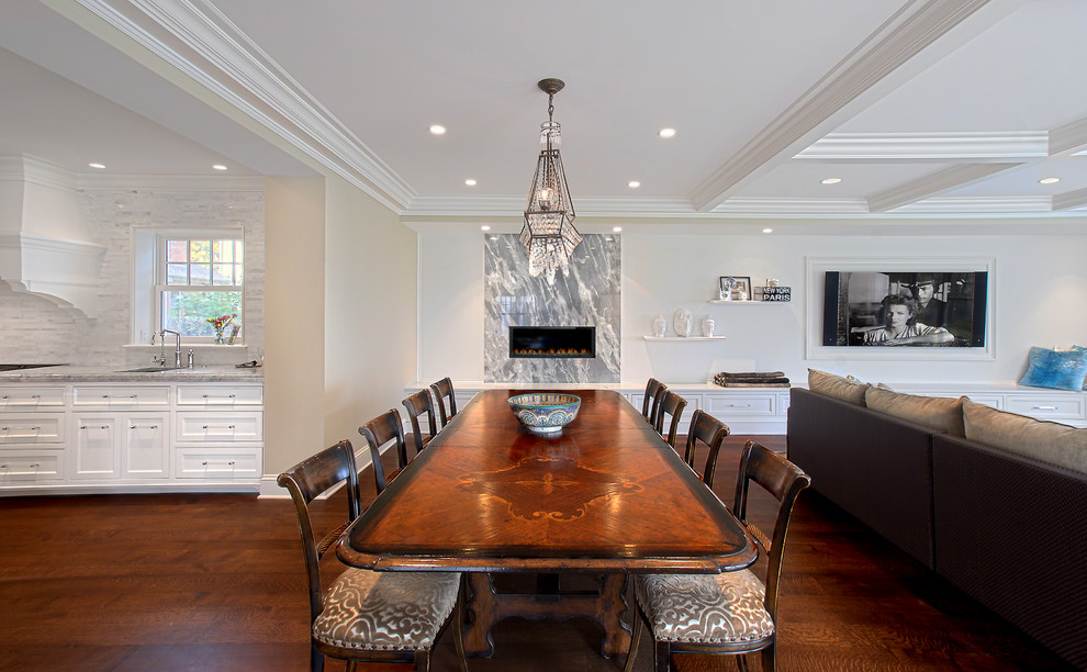 Example of a mid-sized transitional dark wood floor, brown floor and coffered ceiling kitchen/dining room combo design in Chicago with a standard fireplace, a stone fireplace and white walls