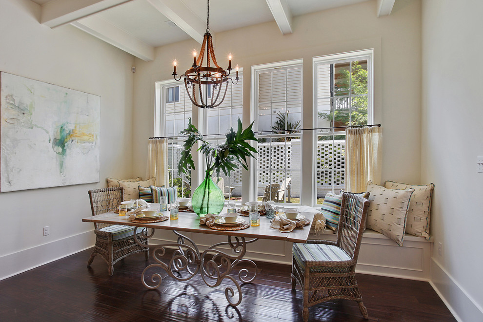 Example of a small beach style dark wood floor enclosed dining room design in New Orleans with white walls and no fireplace