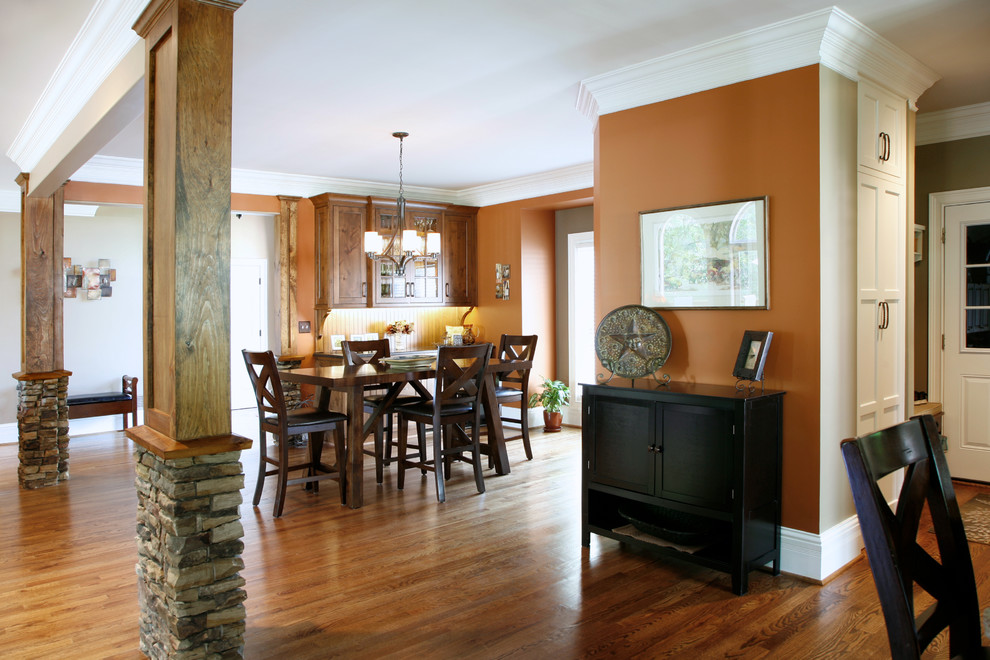 Contemporary open plan dining room in Atlanta with orange walls and medium hardwood flooring.