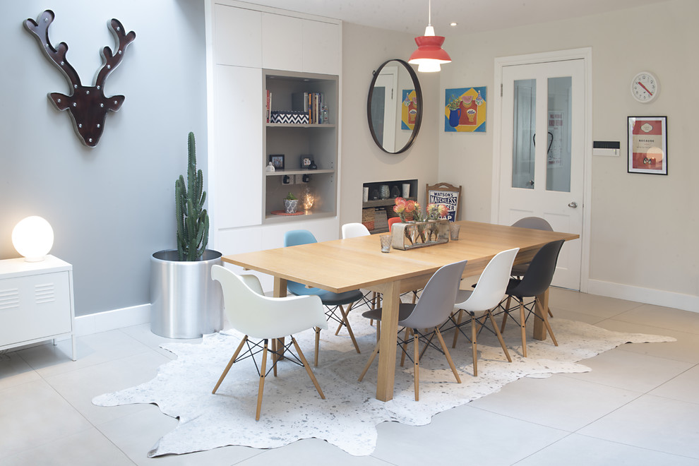 This is an example of a medium sized contemporary dining room in London with grey walls and porcelain flooring.