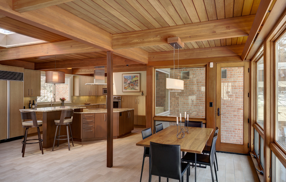 Cette image montre une salle à manger ouverte sur le salon vintage de taille moyenne avec un sol en carrelage de céramique, une cheminée double-face et un manteau de cheminée en brique.