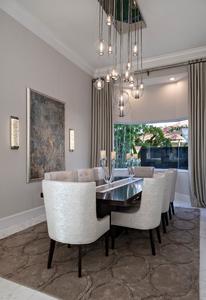 Design ideas for a contemporary enclosed dining room in Miami with beige walls and white floors.