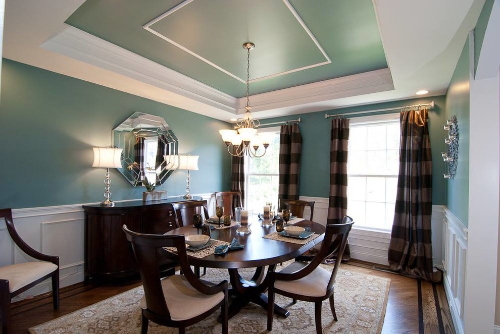 Design ideas for a medium sized traditional enclosed dining room in New York with blue walls and medium hardwood flooring.