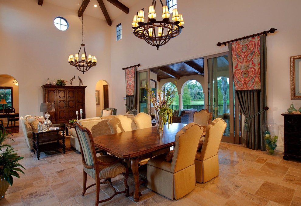 This is an example of a large mediterranean open plan dining room in Orlando with white walls, travertine flooring and beige floors.
