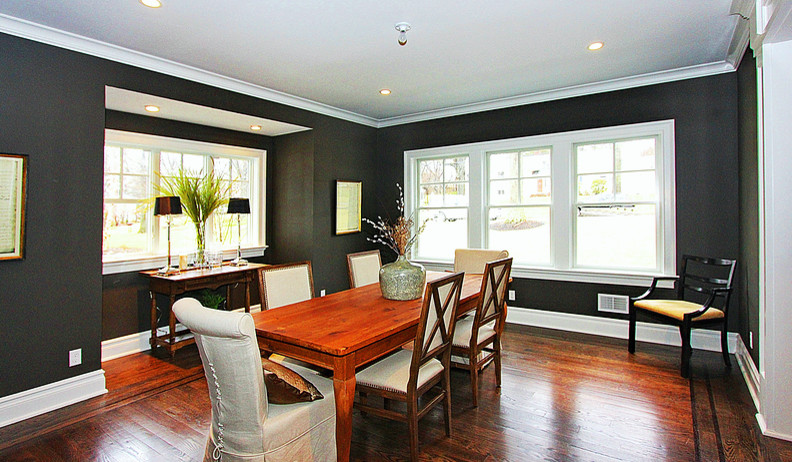 Medium sized classic kitchen/dining room in New York with black walls, dark hardwood flooring and no fireplace.
