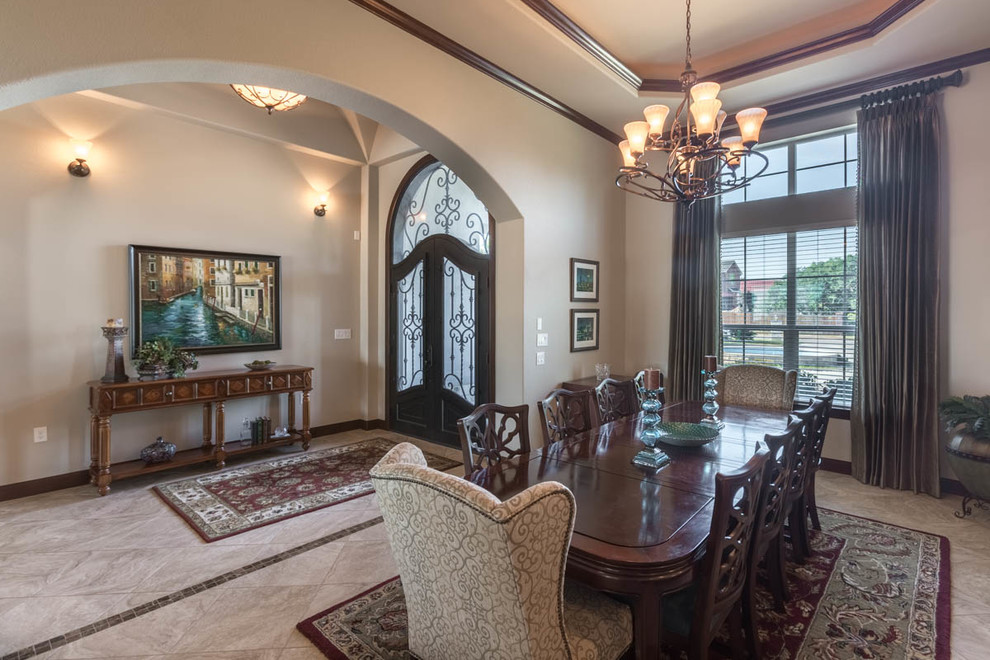 Foto di una sala da pranzo aperta verso il soggiorno stile americano di medie dimensioni con pareti beige, pavimento in travertino e nessun camino