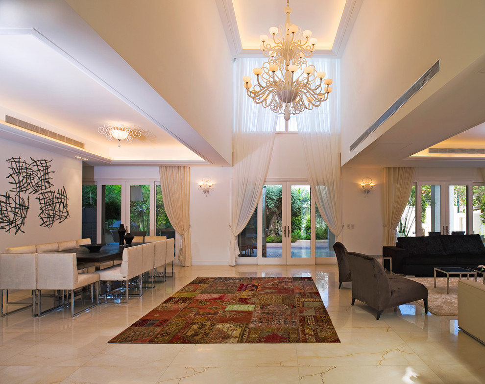 This is an example of a mediterranean open plan dining room in Tel Aviv with feature lighting.