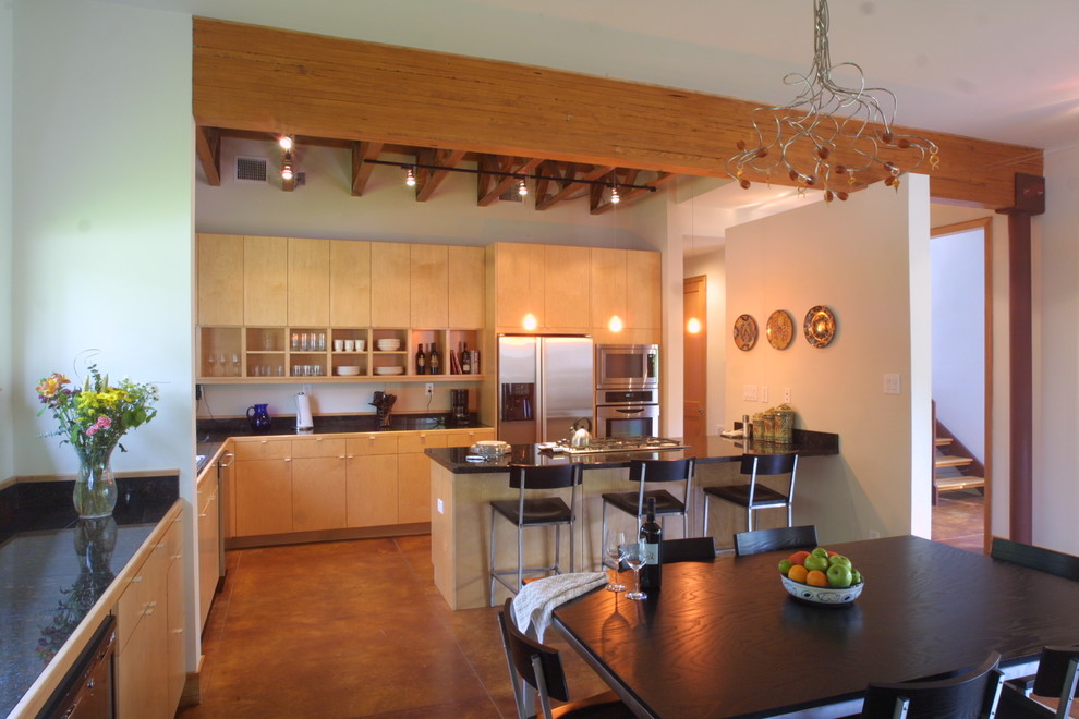 Idéer för ett mellanstort modernt kök med matplats, med vita väggar, betonggolv och brunt golv