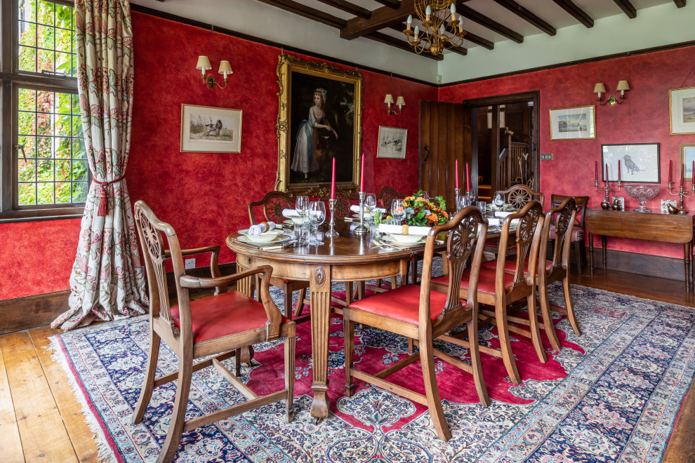Inspiration pour une grande salle à manger traditionnelle avec un mur rouge.