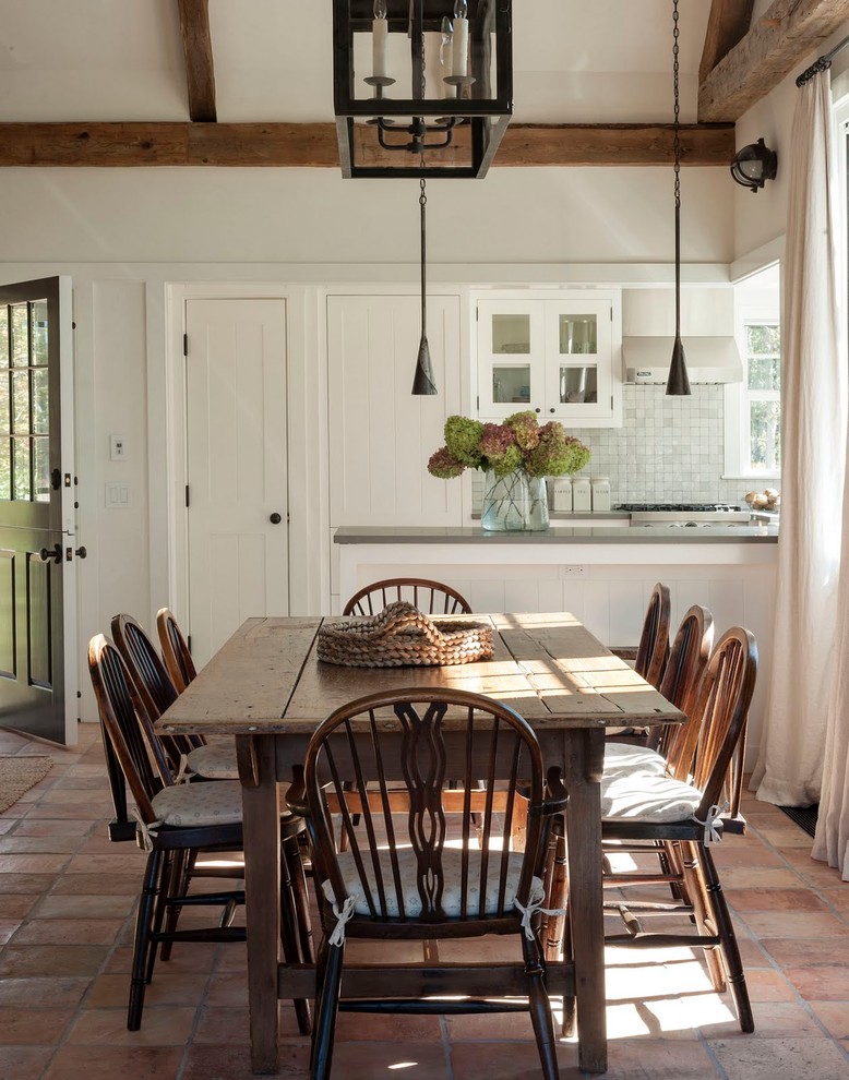 Example of a cottage dining room design in Boston with white walls