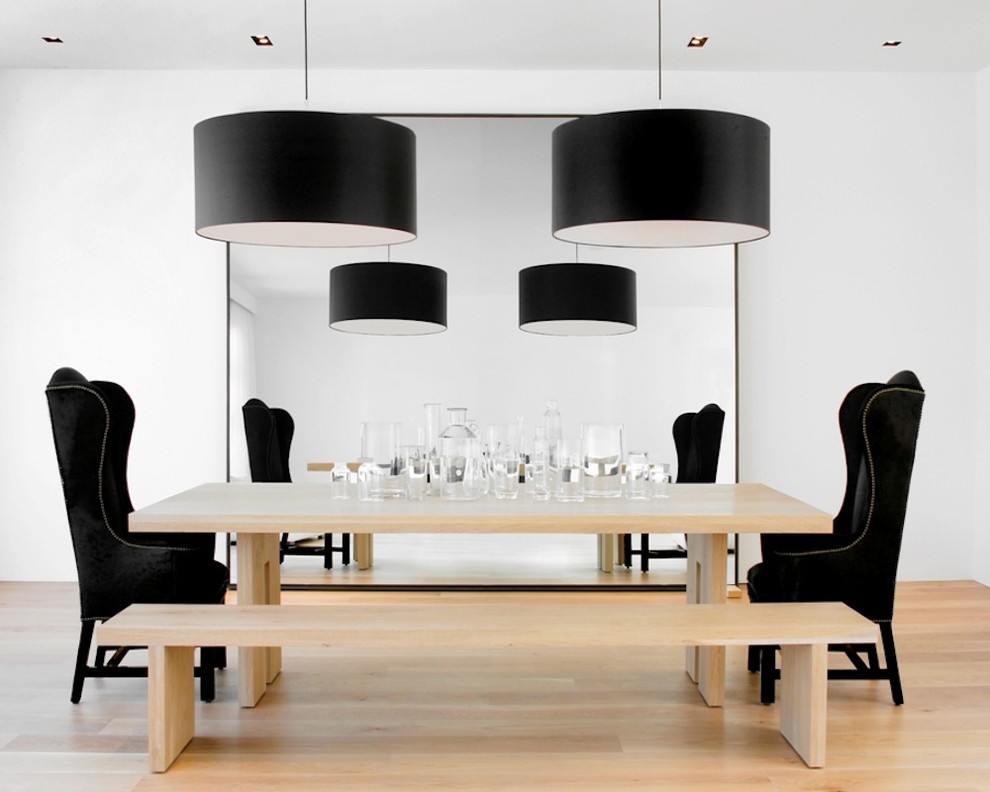 Photo of a modern dining room in San Francisco with white walls and medium hardwood flooring.