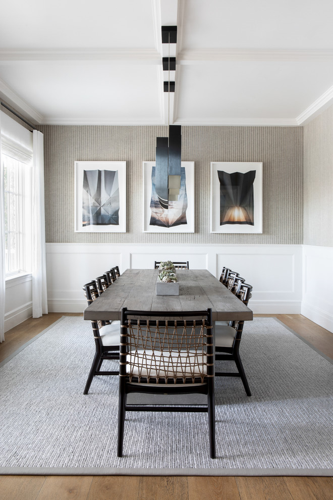 Example of a large minimalist light wood floor and beige floor enclosed dining room design in New York