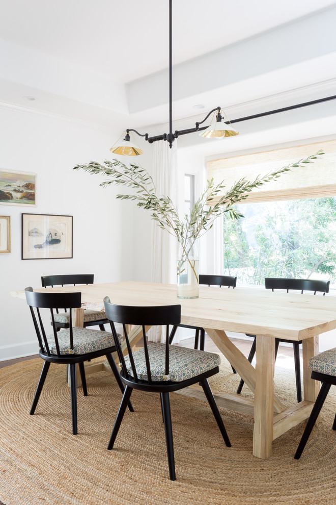 Example of a beach style dining room design in Los Angeles with white walls and no fireplace