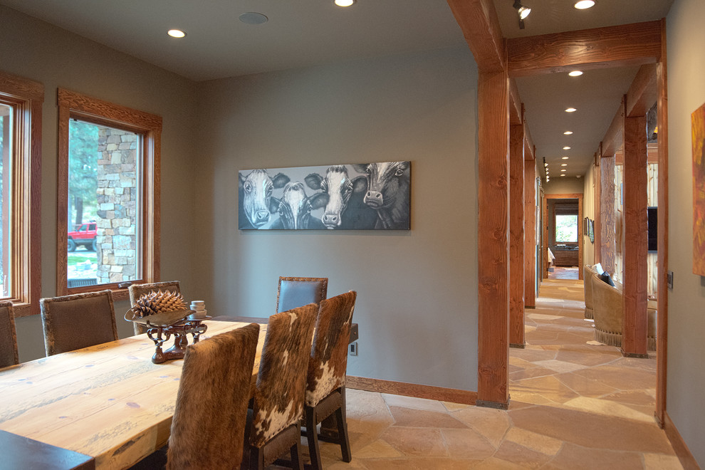 This is an example of a large rustic enclosed dining room in Albuquerque with green walls.